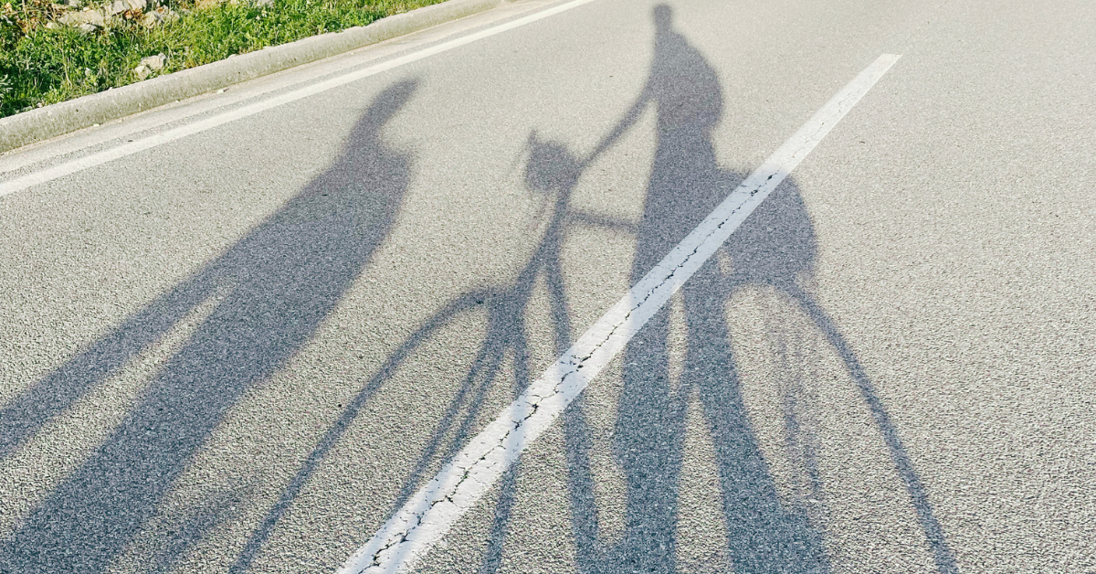 shadows of two people on bikes for the Posts by Activity page - Featured Image